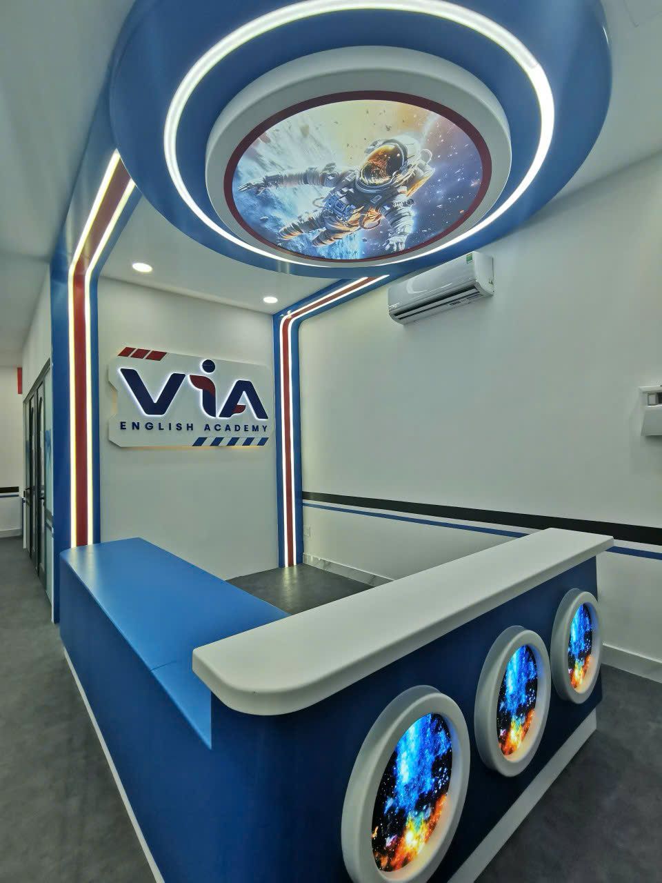 VIA English Academy reception desk with a round space-themed ceiling