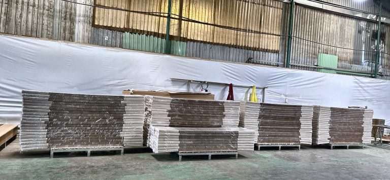 Wrapped furniture on pallets awaiting transport to Lam Dong