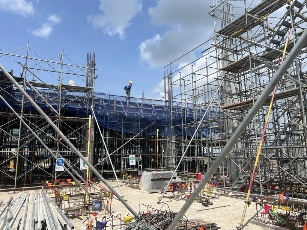 Scaffolding, walkways and safety signage on a factory construction site