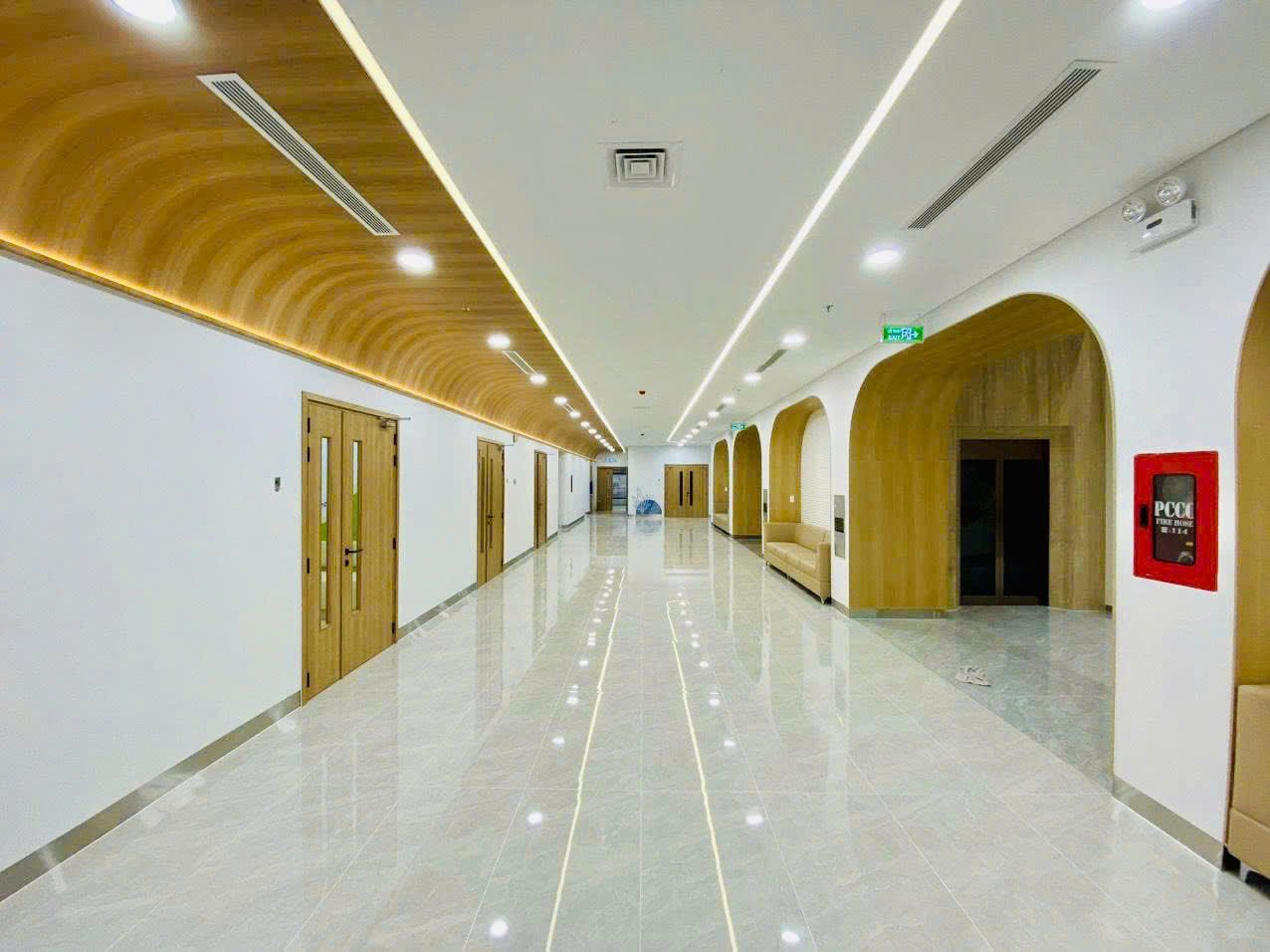 Finished examination corridor – timber ceiling, exit lighting, fire hose cabinet